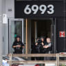 Montreal Police officers stand at the entrance to a building after a fatal shooting in which a police officer was killed in the Cote-des-Neiges neighbourhood, Montreal police say, in Montreal, Quebec, Canada, June 22, 2026.