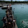 Vacationers enjoy swimming at the beach of Le Bourget lake in Le Bourget-du-Lac, central eastern France, on August 8, 2025. 