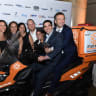 Group of United Hatzalah Young Leadership photographed at the New York gala with a United Hatzalah ambucycle