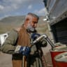 A vendor pumps petrol from Iranian fuel oil tankers for resale near the Bashmagh border crossing on March 11, 2026. 