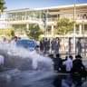 Israel Police officers spray water jets at haredi (ultra-Orthodox) protesters blocking the road outside Supreme Court Justice Noam Sohlberg's residence in Jerusalem, June 10, 2026; illustrative.