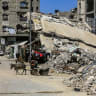 Palestinians walk among buildings destroyed during the recent war in Khan Younis, southern Gaza Strip, June 23, 2026.