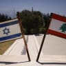 Israeli and Lebanese flags are pictured at a monument called the "Good Fence" in the northern town of Metula bordering Lebanon on June 18, 2026. 