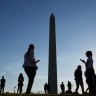 People wait for the flyover near the Washington Monument during a rally kicking off the Great American State Fair marking the 250th anniversary of US independence on the National Mall in Washington, DC, US, June 24, 2026.