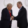 US President Donald Trump and Turkish President Recep Tayyip Erdogan shake hands as they pose for a photo at a world leaders' summit in Sharm el-Sheikh, Egypt, October 13, 2025