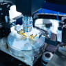 A close-up of a test sample of a transistor chip under a microscope in the laboratory (illustrative)