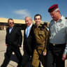 In this handout photo provided by the IDF, freed Israeli soldier Gilad Shalit (2nd R) walks with Defence Minister Ehud Barak (L), Israeli Prime Minister Benjamin Netanyahu (2nd, L) and IDF Chief of General Staff Benny Gantz (R) at Tel Nof Airbase on October 18, 2011 in central Israel.