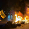 HEZBOLLAH SUPPORTERS block the old airport road in the southern suburbs of Beirut, with burning tires to protest against the trilateral agreement that was signed between the US, Israel and Lebanon on June 27, 2026.