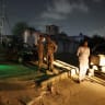 Security personnel stand guard after an explosion and gunfire were reported, near offices of the Rangers, a paramilitary force, in Karachi, Pakistan, June 27, 2026.
