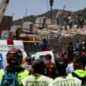Emergency services work at the site of a collapsed building following earthquakes that hit the country, in Caracas, Venezuela, June 26, 2026.