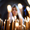 Members of the Armenian community in Jaffa perform a pray during a memorial service held to mark the 106th anniversary of the Armenian Genocide, at the Armenian Church of Saint Nicholas, in Jaffa, April 24, 2021. 