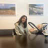 Swedish environment minister Romina Pourmokhtari sits in a meeting room with her baby, at a meeting of EU climate ministers in Luxembourg, June 25, 2026. 