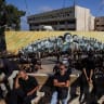Shi'ite mourners gather near a banner depicting late former Hezbollah leader Hassan Nasrallah and and other senior figures as they mark Ashura, the holiest day on the Shi'ite Muslim calendar, in the southern suburbs of Beirut, Lebanon, June 26, 2026. 