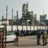 Security personnel stand outside the complex of Indian Oil Corporations (Indian Oil Corporation) IOCs refinery in Haldia, West Bengal on December 22, 2021 a day after three people reportedly lost their lives in a fire incident in the plant.