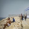 Israelis enjoy the beach as a heatwave hits Israel, in Herzliya, April 17, 2026