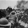 British infantry soldiers running out of their trenches at the signal to assault  the Somme, France, 1916. 