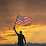 Man holding an American flag.