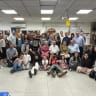 Torah Dedication Ceremony: More than half of the Kahn family living in Israel surrounds the Torah scroll, which their family helped save close to a hundred years ago.