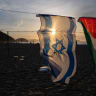 An Israeli and a Palestinian flag hang on an installation set up by members of the Brazilian NGO Rio de Paz at Copacabana beach in Rio de Janeiro, Brazil, on October 4, 2025