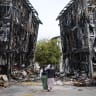 People look at burned-down buildings after a magnitude 7.2 earthquake struck Venezuela and other regions in the Caribbean on June 30, 2026 in Caracas, Venezuela.