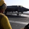 A screengrab from a video released by U.S. Central Command (CENTCOM), which accompanied a press release describing the operation dubbed "Epic Fury", an attack by the United States and Israel on Iran, shows a flight deck crew member signaling an F‑35 jet on an aircraft carrier