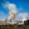 FIREFIGHTERS AND Palestinians extinguish a fire in agricultural fields near the town of Huwara in the West Bank, after an alleged attack by Israeli settlers.