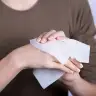 Illustration: Woman using a wet wipe