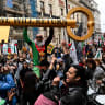 A man holds a mock-up of a key during a march, held by Palestine Solidarity Campaign, to mark the 78th anniversary of the Nakba and against the "Unite the Kingdom" rally taking place in London organised by British anti-immigration activist Stephen Yaxley-Lennon, also known as Tommy Robinson, in Lond