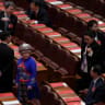 A delegate in ethnic minority costume arrives before the closing session of the National People's Congress (NPC) at the Great Hall of the People in Beijing, China March 12, 2026.