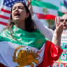 A protestor demonstrates against the Islamic Republic of Iran, while wearing an Iranian pre-revolutionary flag, outside Los Angeles Stadium ahead of the Iranian national soccer team’s World Cup match on June 15, 2026 in Los Angeles, California.