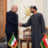 Iranian parliament speaker Mohammad Bagher Ghalibaf (L) shakes hands with Omani Foreign Minister Badr bin Hamad Al Busaidi (R) before a meeting in Muscat, Oman, on June 22, 2026. 