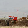  TURKEY-IRAQ-KURDS-MILITARY-DRILL A photographer takes pictures as soldiers stand next to tanks bearing Turkish and Iraqi flags during a joint military exercise near the Turkish-Iraqi border at Silopi district in Sirnak on September 26, 2017.