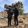 Palestinian Hamas terrorists stand guard at a site as Hamas says it continues to search for the bodies of deceased hostages, in Beit Lahiya in the northern Gaza Strip December 3, 2025.