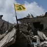 A yellow flag belonging to the Iran-backed Shia Muslim party Hezbollah flutters on top of the rubble of a building in the southern Lebanese coastal city of Tyre on June 23, 2026.