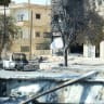 A Syrian Druze fighter kneels in the entrance of a building in the predominantly Druze city of Sweida in southern Syria on July 20, 2025.