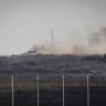 An Israeli tank patrols inside the Gaza Strip, as seen from the Israeli side of the border, June 21, 2026.