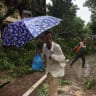 A worker clears fallen trees after heavy rainfall in Mumbai, India, July 5, 2026.
