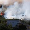 A helicopter conducts firefighting operations as wildfire burns in Pouzols-Minervois near Narbonne, France, July 2, 2026.