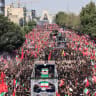 Mourners gather around the coffins of Iran's slain supreme leader Ali Khamenei and members of his family as the funeral procession heads towards Azadi Square in Tehran on July 6, 2026