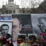 Flowers and candles are arranged next to pictures of late Russian opposition leader Alexei Navalny at a makeshift memorial, in front of the Russian embassy in Berlin on February 17, 2026.