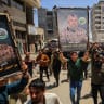 Mourners carry images of Hamas' military wing commander Izz al-Din al-Haddad during a funeral, in Gaza City, May 16, 2026.
