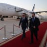 France's President Emmanuel Macron (L) is welcomed by Syria's Foreign Minister Asaad al-Shaibani (R) as he arrives for a state visit at the Damascus International Airport in Damascus on July 6, 2026.