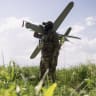 A member of the Lava Unmanned Systems Regiment, Norman, poses for a photograph with a Bulava strike drone, a kamikaze UAV capable of carrying a 3.5-kilogram payload with a range of up to 100 kilometers in Kharkiv region, Ukraine.