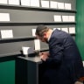 Dov Bleich writing a Yiddish prayer for America’s next 250 years at the Museum of the American Revolution in Philadelphia.