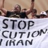 Fans holds the banner reading 'Stop Execution in Iran' before the FIFA World Cup 2026 Group G match between Belgium and IR Iran at Los Angeles Stadium on June 21, 2026.