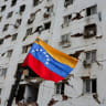 A Venezuelan flag flutters near a damaged building, in the aftermath of the deadly June 24 earthquakes, in La Guaira, Venezuela, July 6, 2026.