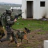 Officers of the Nachal brigade train with Israeli soldiers from the Oketz unit in an urban warfare, at the mock village of El Poran, in northern Golan Heights, on December 7, 2022. 