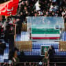 A vehicle carrying the coffin of Iran's slain Supreme Leader Ayatollah Ali Khamenei makes its way as people attend Khamenei's funeral procession, in Najaf, Iraq, July 8, 2026