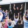 DJ Raphi entertains the kids, leading them through fun dance moves set to catchy music.