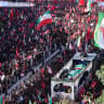 Crowds of mourners surround the convoy carrying the coffins of Iran's slain supreme leader Ali Khamenei during a funeral procession, in Mashhad, July 9, 2026